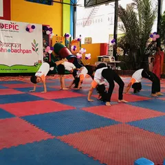 Our students showcase their amazing flexibility and teamwork during a group gymnastics performance. This backbend formation demonstrates the strength and coordination they develop in our programs.