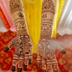 This bridal mehendi is full of auspicious symbols, including Lord Ganesha, elephants, and kalash motifs. The couple's initials "MS" are also personalized on the arm.