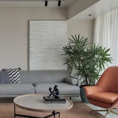 This large, textured fabric art piece, featured in Trends Magazine, adds a minimalist and sculptural element to a modern living room. The subtle folds and shadows create a sense of calm and sophisticated simplicity.