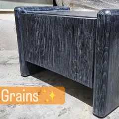 Here is a modern side table with a black grain finish being prepared in the workshop. You can see the raw materials and other projects in the background.