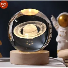 This crystal ball lamp features a 3D laser-engraved Saturn inside, sitting on a warm LED wooden base. It's a mesmerizing piece of decor for any office or home.