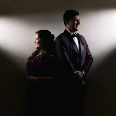 A powerful and creative couple portrait using dramatic spotlights. This technique creates a sense of mystery and highlights their profiles, making for a unique engagement photo.