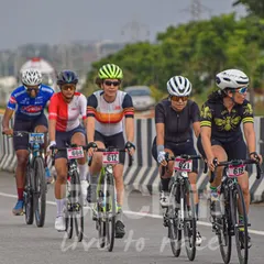 Our women's category is fierce and competitive. Here, a group of strong female cyclists work together in a paceline during a road race, showcasing incredible teamwork and athleticism.