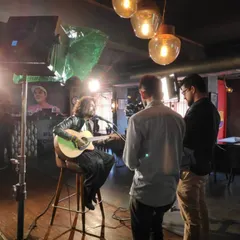 Behind the scenes during a music video shoot. Here I am performing a track on camera, showing how I work with the production crew to get the perfect shot that matches the song's energy and narrative.