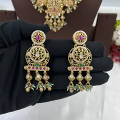 An antique-style necklace set with intricate detailing and multi-color stones, shown from different angles.