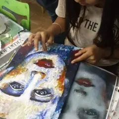 Here, a young student is learning to create a portrait using a reference image. The process of observing, sketching, and applying color is a journey in itself. It is about enjoying every moment of creation.