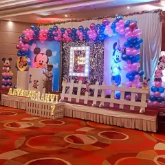 Another angle of the birthday stage, showing the white picket fence detail and balloon columns. These small touches add depth and complete the themed look.