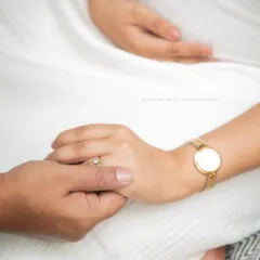 A simple, powerful close-up of a couple holding hands, symbolizing their partnership and shared journey into parenthood.
