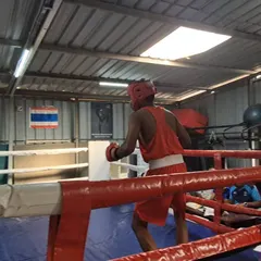 A boxer warms up in the corner of the ring. The moments before a fight are about focus and mental preparation, a key part of our training.