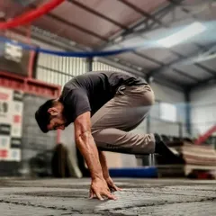 Another angle of the tuck planche, showing the arm and shoulder engagement. Notice the forward lean and protraction of the shoulders, which are key to this movement.
