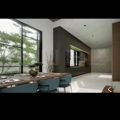 The dining area is positioned to offer serene views of the surrounding greenery through large windows. We use natural materials like the wooden dining table and earthy tones in the decor to complement the outdoor landscape.