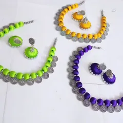 More custom silk thread sets, here in neon green, yellow, and purple. The necklaces are finished with oxidised silver-tone coin charms for a bohemian touch.