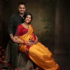 A beautiful couple's portrait celebrating their culture. The way her yellow and red saree complements the festive, candle-lit setup is just magical.