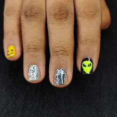 Express yourself with quirky nail art. This fun set for men includes a mix of hand-painted icons like a smiley face, a mushroom, and an alien.