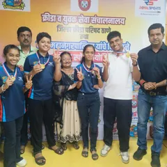 A group of our medal-winning students and their families pose with our director. This photo captures the community and support system that surrounds our young athletes.