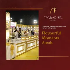 A glimpse of our customized catering setup for an evening celebration. The warm, golden lighting on the white counters creates a luxurious and inviting atmosphere for guests as they explore the gourmet food offerings.