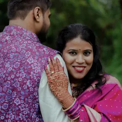 An intimate engagement portrait. The bride-to-be rests her head on her partner's shoulder, her hand showing off the beautiful henna and engagement ring. It's a shot that captures connection and happiness.