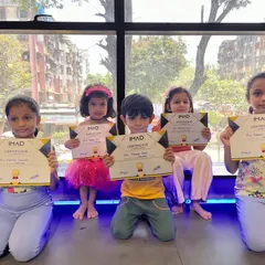 A group of our younger gymnasts proudly displaying their IMAD certificates. Our programs are designed for kids of all ages, with a focus on fun and achievement.