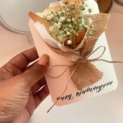 A handmade birthday card featuring a mini bouquet of dried baby's breath. It's simple, aesthetic, and adds a personal touch that you can't find in a store bought card.