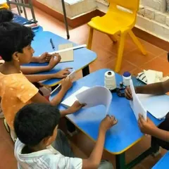 A group of children completely engaged in a bookbinding workshop at Poorna Learning Centre. We partner with schools and community centers to make repair skills accessible to as many kids as possible.
