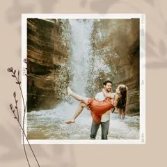 A romantic and playful shot of him lifting her in front of a waterfall, capturing a moment of carefree joy and adventure.