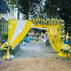 This is another view of the vibrant haldi ceremony entrance, showing how the fabric and floral arch creates a welcoming gateway for guests. The decor is designed to complement the sunny, outdoor setting.