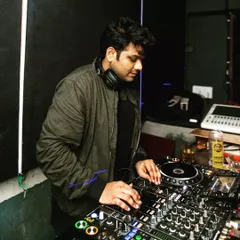 Focused in the zone, mixing tracks at a recent club gig. Every set is about reading the crowd and creating a seamless flow of music that keeps everyone on the dance floor.