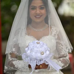 A beautiful portrait of the bride. The soft lighting highlights the glowing skin and the delicate shimmer on her eyes.