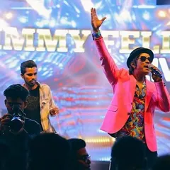 In my element with the band, bringing the energy for a corporate awards night. The pink jacket was just for that extra flair.