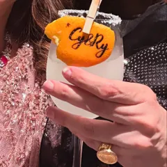 It's the personal touches that make an event unforgettable. We love creating unique details like this custom-stamped orange peel garnish, featuring the couple's initials, to make their signature cocktail truly their own.