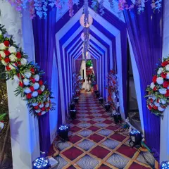 I create grand entrances that make a statement. This tunnel-style entrance for an engagement ceremony uses custom draping and a series of uplights to build excitement and provide a stunning photo opportunity for guests as they arrive.