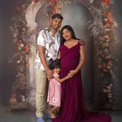 A beautiful family portrait in our floral arch setup, with their young daughter sharing in the special moment.