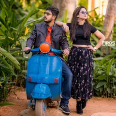 A cool, stylish pose with a vintage scooter. The couple's modern casual wear and sunglasses create a fun, edgy look for their pre-wedding photos.