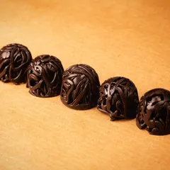 These intricate chocolate sculptures, shot for Morde Chocolate, show the artistic potential of the ingredient. The lighting is designed to highlight the delicate details and smooth gradients of the chocolate.