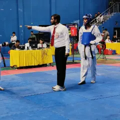 Officiating a match at the Taekwondo Open selection trial for the 38th National Games. It is an honor to be part of the selection process for our country's top athletes.