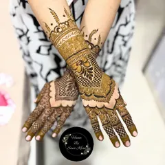 This design showcases a beautiful blend of geometric patterns like the checkerboard fill with classic floral and leaf motifs. The heavy cuff and detailed finger work make it a perfect choice for a bride.