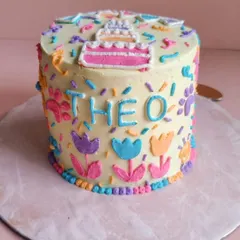 Another view of Theo's cake, showing his name clearly spelled out. Personalization is key to making your doggie baby feel celebrated.