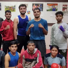 The evening training team posing for a group photo. We are a diverse group of male and female boxers united by our passion for the sport and our drive to succeed.