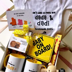 The sweetest way to share the best news! This pregnancy announcement hamper for the 'dada' and 'dadi' to be is filled with personalized mugs, a 'Baby on Board' sign, and a custom onesie to make the moment truly special.