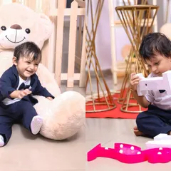 Capturing candid moments during a first birthday party. The birthday boy plays with props and a giant teddy bear, showing the fun and relaxed atmosphere we create for our little clients.