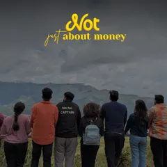 It's not just about money, it's about the people. A group stands together, looking out at the mountains in Kodai. My off-beat trips are about connection and shared moments.