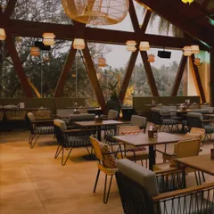 The interior of our Botanica restaurant, with its unique A-frame wooden architecture and views of the surrounding greenery, offers a stunning setting for a meal.
