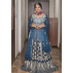 This blue and silver lehenga is a true statement piece. The geometric and metallic patterns make it a very modern and eye-catching choice for an evening event.