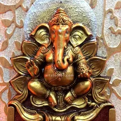 A detailed view of the Ganesha sculpture from the commercial nameplate. The antique gold finish and intricate details on the idol demonstrate the high level of artistry we bring to every project, whether residential or commercial.