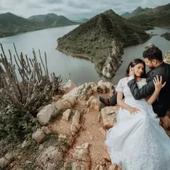 A tender embrace overlooking the stunning lakes and hills of Udaipur. We focus on capturing these gentle, unposed interactions that reveal the true connection between a couple, set against an epic natural backdrop.
