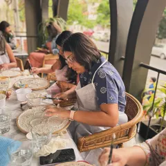 A table full of participants getting hands-on with the texture paste to create the moon's surface. This is the fun, messy part.