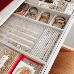 An organized jewelry drawer makes getting ready a pleasure. We use a combination of sectioned trays for bangles, velvet-lined inserts for rings, and clear pouches for sets.