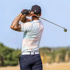 This image showcases the powerful coil and shoulder turn we teach our students. Proper technique at the top of the backswing is key to an effective downswing.