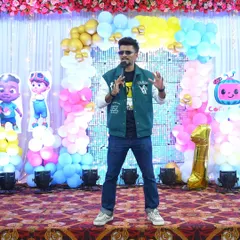 Another shot of me hosting a first birthday party, engaging with the little ones and their parents.