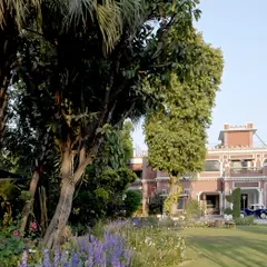 The home is enveloped by a lush garden, where seasonal flowers and mature trees create a living landscape that changes throughout the year. This connection to nature was a guiding principle in our restoration of the interiors.
